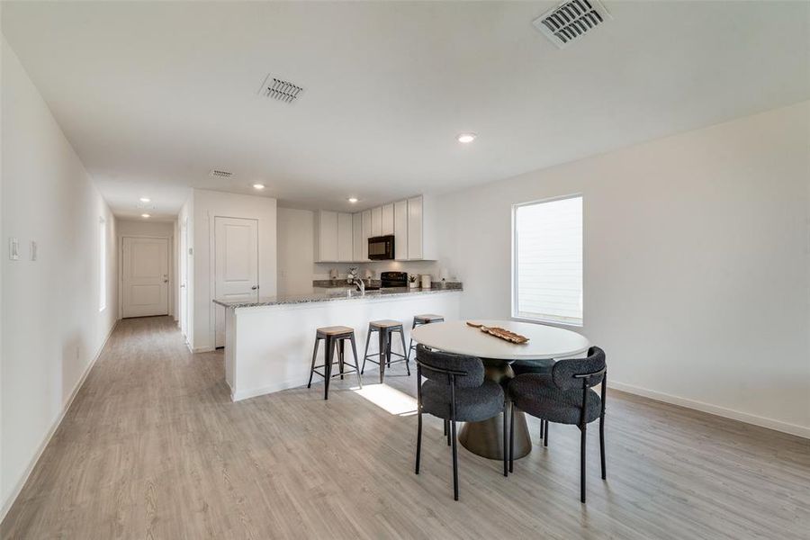 Dining area with light hardwood / wood-style floors