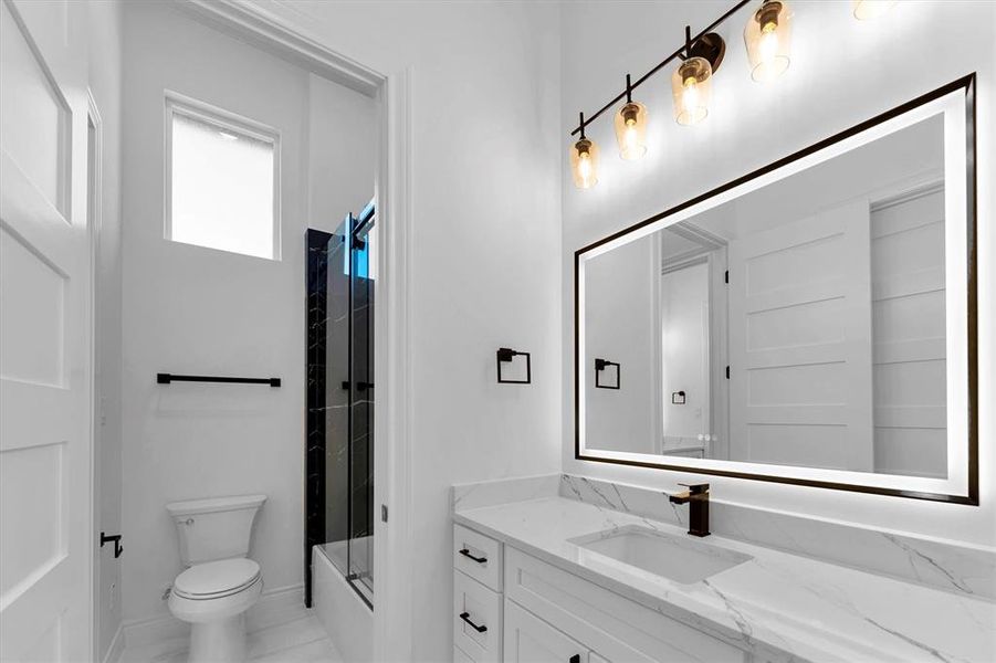 The second bedroom has it's own private vanity with sink, anti-fog LED mirror, quartz countertop and undercabinet storage.