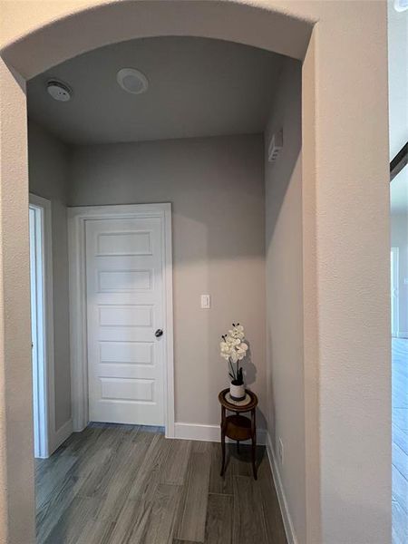 Hallway with dark hardwood / wood-style floors