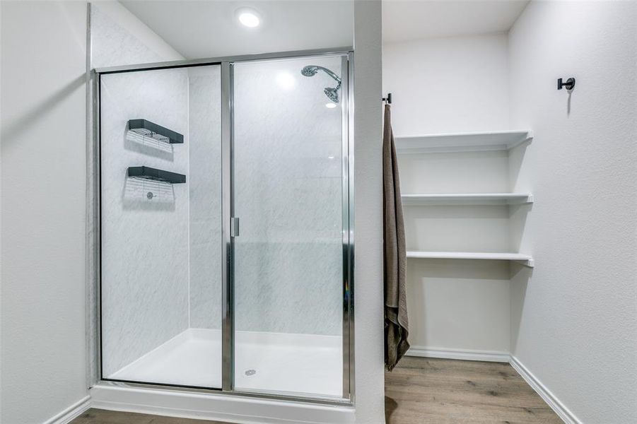 Bathroom with wood-type flooring and an enclosed shower