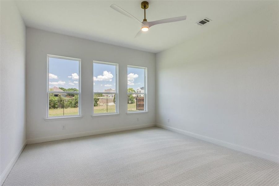 Unfurnished room with light colored carpet and ceiling fan