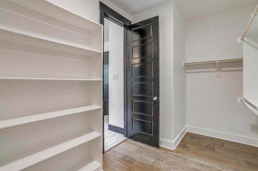 Spacious closet featuring light hardwood / wood-style floors