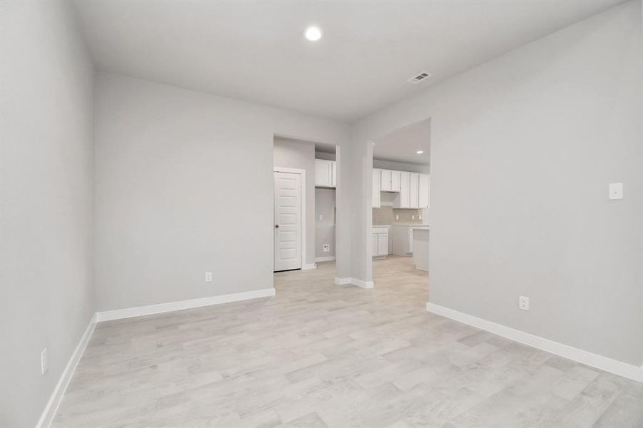 Make memories gathered around the table with your family and friends! This dining spacious room features elegant flooring, custom paint, and adjacent to family room and kitchen for open concept feel. Sample photo of completed home with similar floor plan. As-built interior colors and selections may vary.