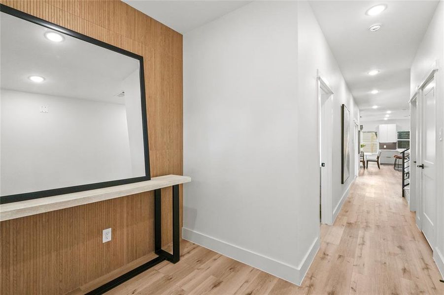 Corridor with light hardwood / wood-style flooring