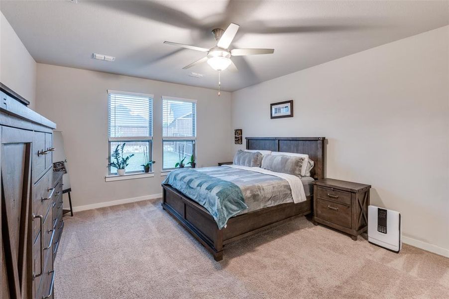 Bedroom featuring ceiling fan and light colored carpet