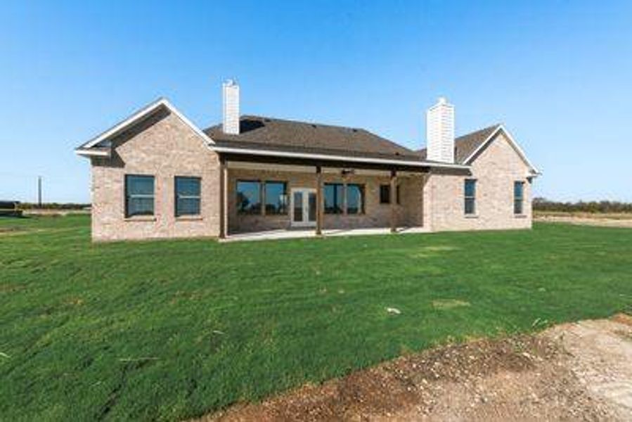 Back of house featuring a yard and a patio area