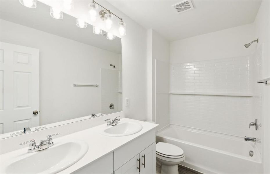Owner's bath with dual vanity and oversized shower *real home pictured