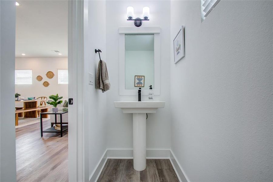 Powder room conveniently located on the first floor. Model home photos - FINISHES AND LAYOUT MAY VARY! Ceiling fans are NOT INCLUDED!