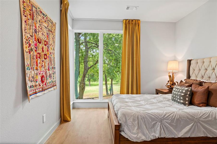 Bedroom with hardwood / wood-style flooring