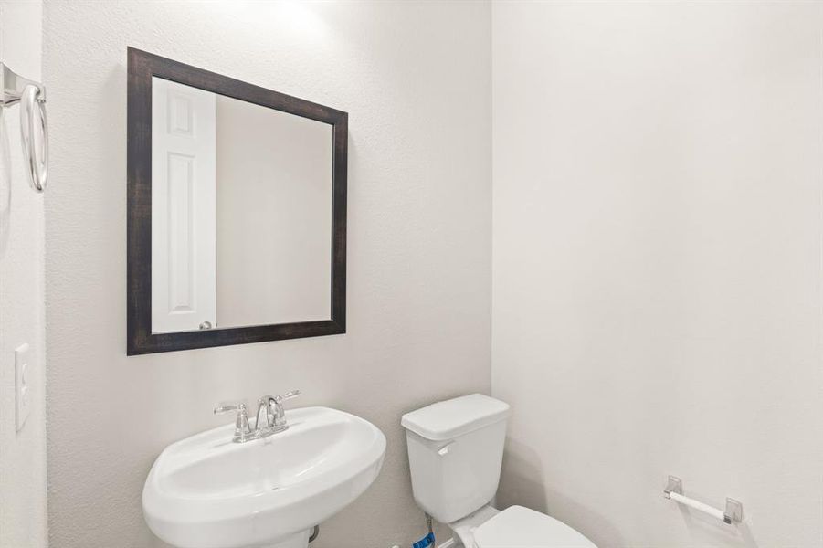 This charming home features a beautifully appointed half bath adjacent to the family room, perfect for welcoming guests and adding convenience to your daily life.