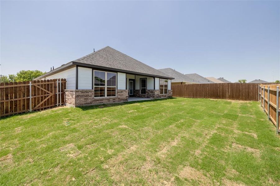 Back of house featuring a lawn