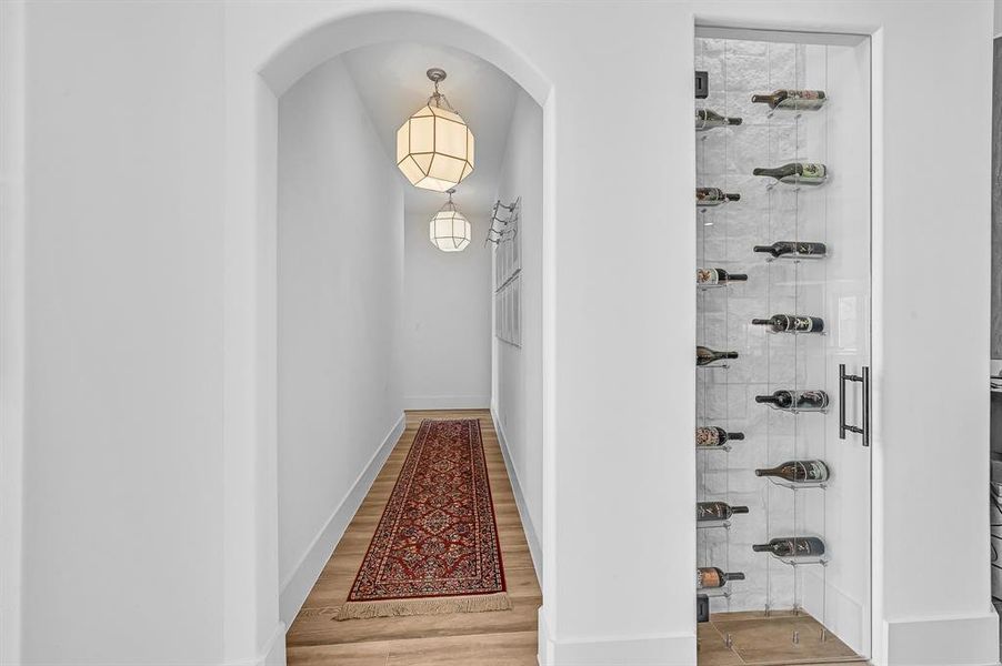 Elegant first-floor corridor leading to a cozy bedroom, featuring a built-in wine rack for the connoisseur.