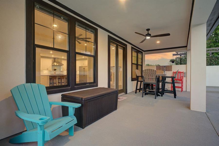 This covered patio area is an extension of the great room, and overlooks the sparkling pool.