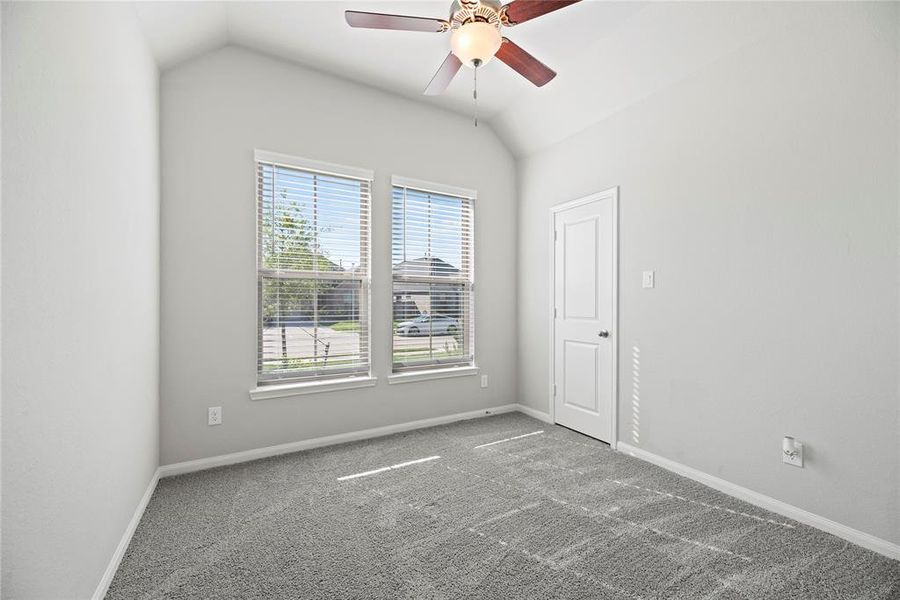 Secondary bedroom with a walk-in closet