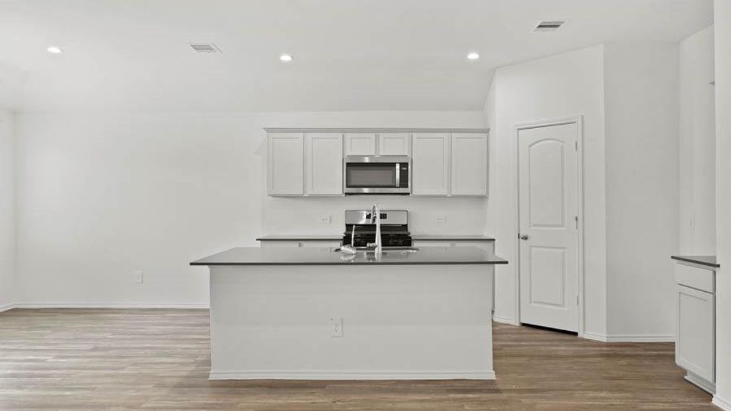 Representative image provided by builder. Subject home will have white countertops.