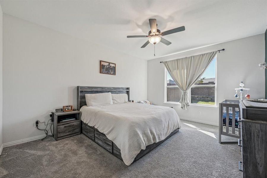 Bedroom featuring ceiling fan and carpet floors