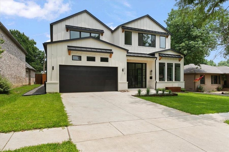 Modern inspired farmhouse with a garage and a front lawn