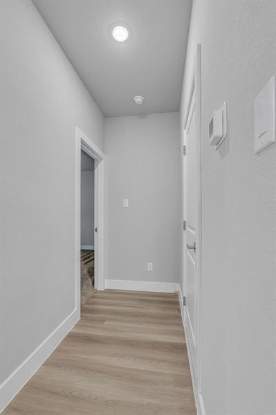 Corridor featuring light hardwood / wood-style flooring