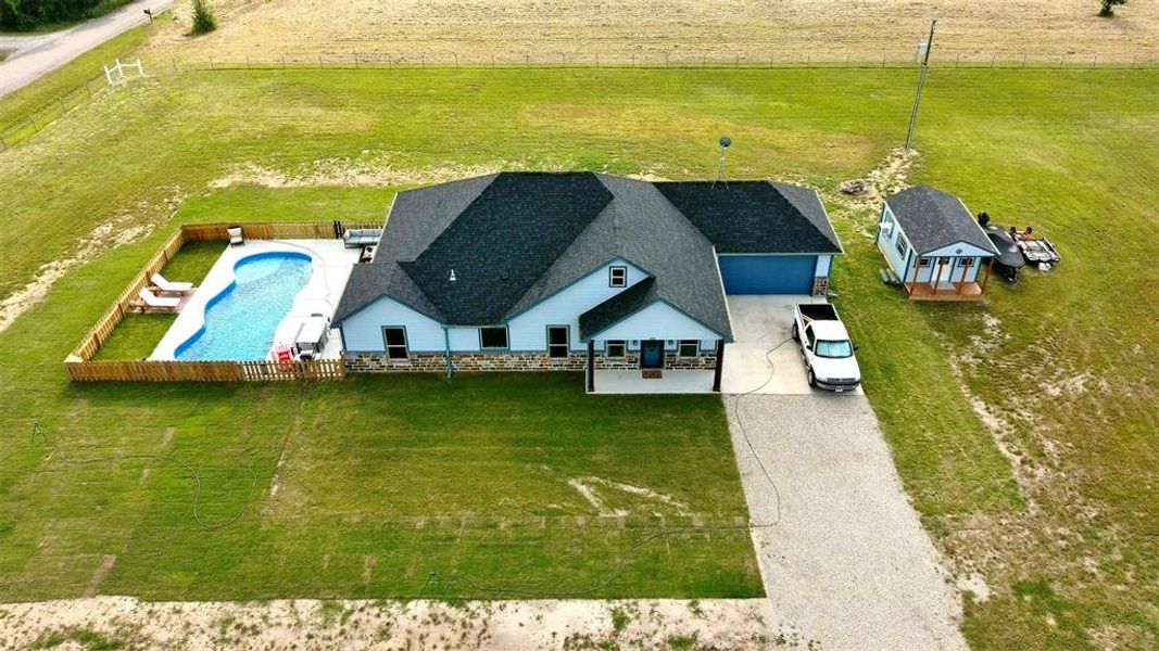 Aerial view of the 1.7 acres showcasing the incredible fiberglass pool and matching shed.
