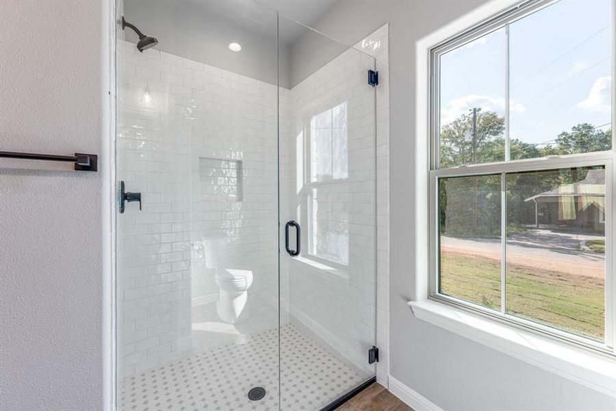 Bathroom featuring walk in shower and hardwood / wood-style flooring