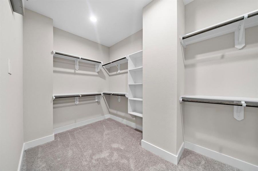Primary Bathroom Closet and an ABUNDANCE of space it has to offer for all your wardrobe needs.