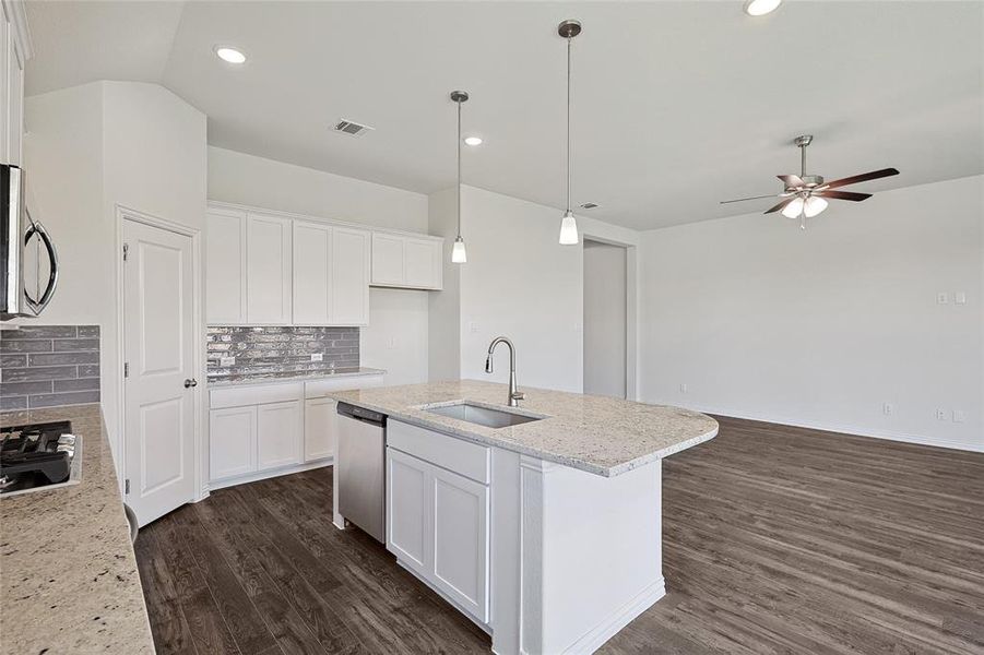 Kitchen with ceiling fan, tasteful backsplash, dark wood-type flooring, sink, and appliances with stainless steel finishes