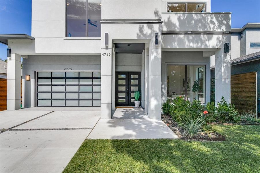 Entrance to property with a yard and a garage