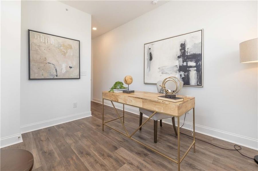 Bedroom featuring dark wood-type flooring, not the actual unit