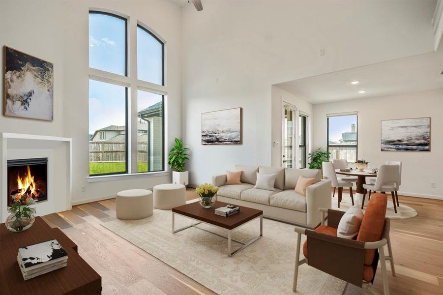 Gather the family and guests together in your huge living room! Featuring soaring high ceilings, dark stained ceiling fan, gorgeous floors, modern fireplace, and large windows that provide plenty of natural lighting throughout the day!   *This room has been virtually staged