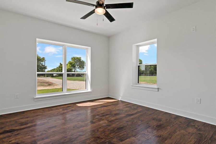 Unfurnished room featuring ceiling fan and hardwood / wood-style floors