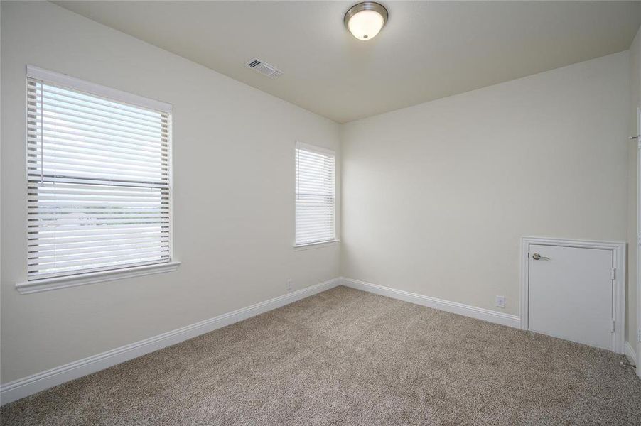 Carpeted empty room featuring plenty of natural light