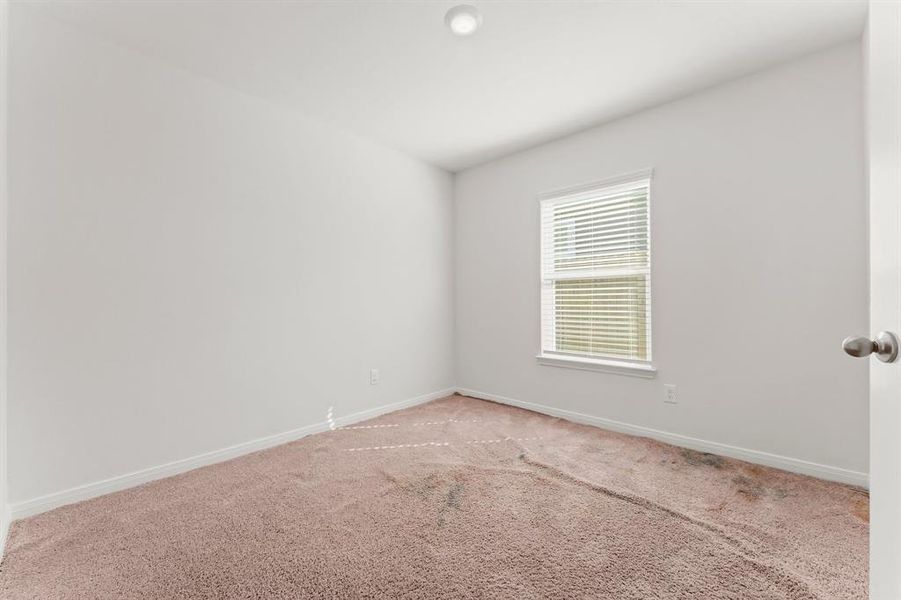 This secondary bedroom features lush carpeting, sunny window with blinds, ceiling light, and wall closet.  It has hallway access to a full bath. The carpeting is going to be replaced in this room with brand new carpeting.