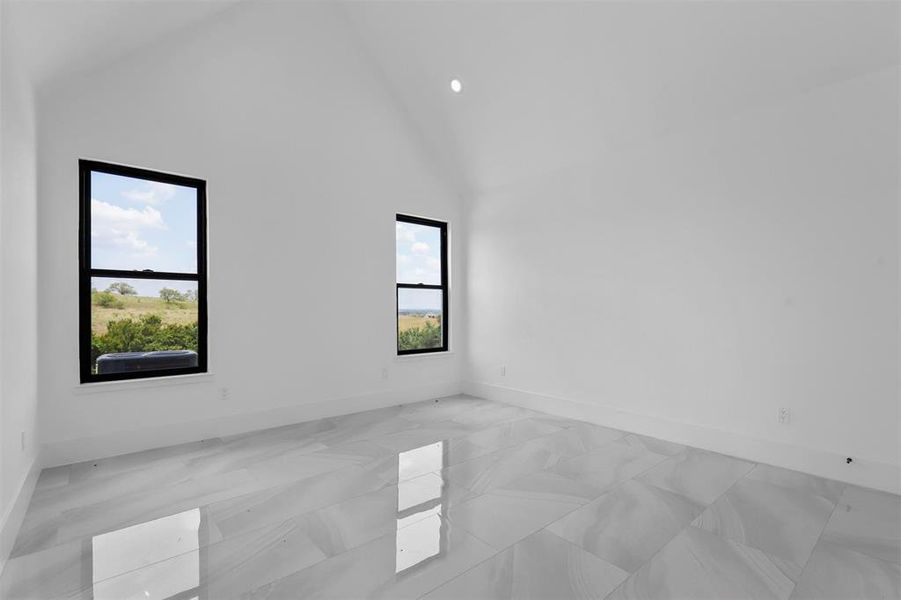 Primary Bedroom featuring high vaulted ceiling