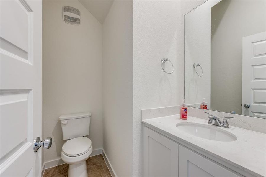 Bathroom featuring tile patterned floors, vanity, and toilet