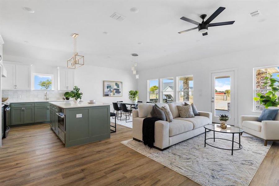 Living room with sink, light hardwood / wood-style flooring, and ceiling fan