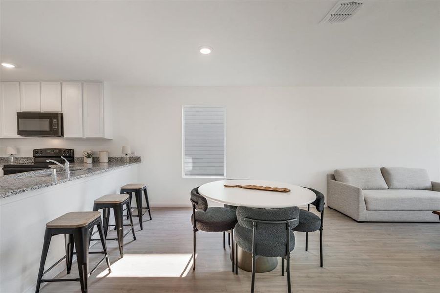 Dining area with light hardwood / wood-style floors