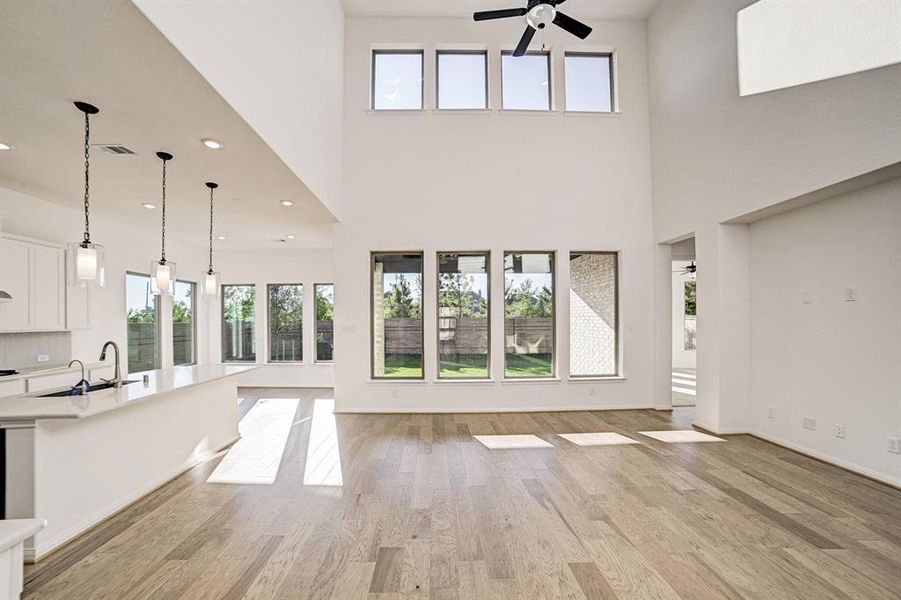 Gorgeous floor to ceiling windows grace the back of the home, allowing plenty of natural light and accentuating the tall ceilings!