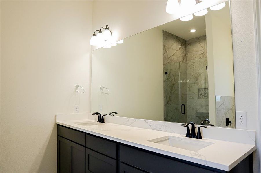 Bathroom with vanity and a shower with shower door