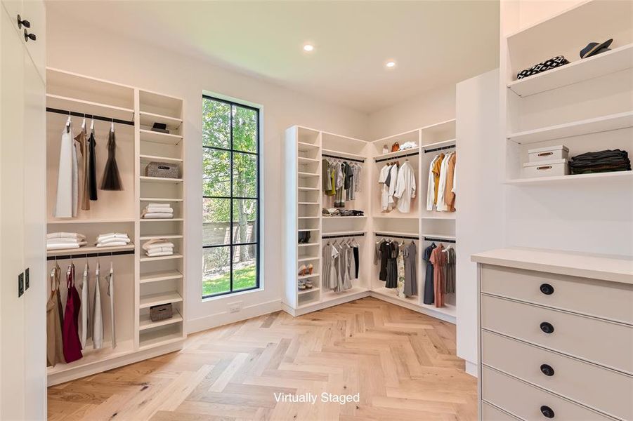 The primary closet has been expertly crafted with custom millwork and a private laundry.