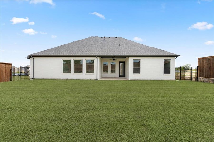 Back of house with a patio, a yard, and ceiling fan