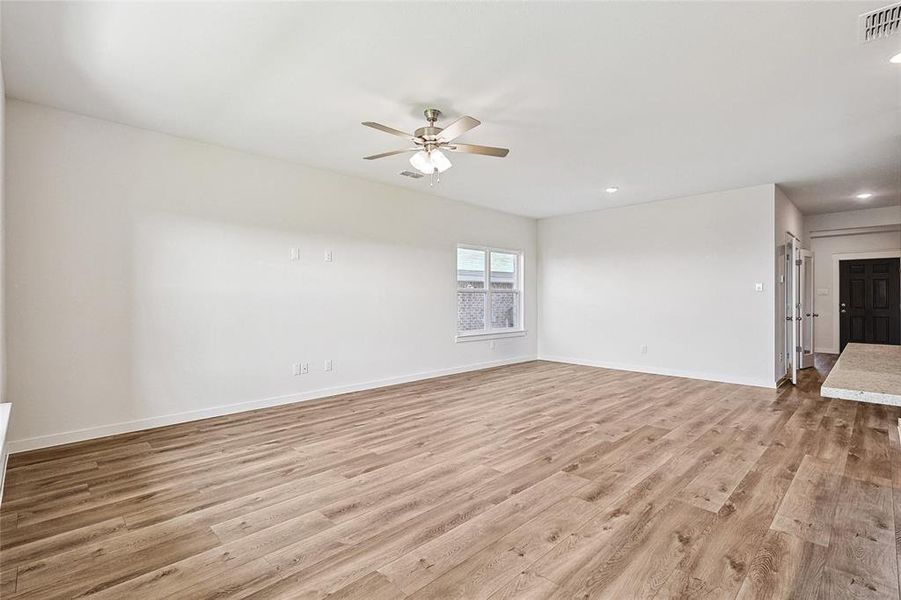 Spare room with light hardwood / wood-style floors and ceiling fan