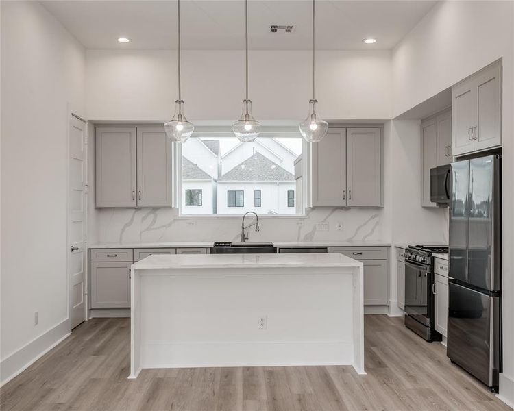 Expansive kitchen island is a perfect spot for entertaining or a quick meal.