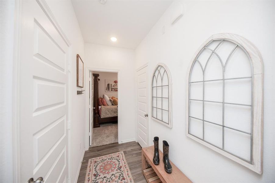 A little further down the way & you come to this little hallway!  On the left is the door to the garage.  The door on the right is a coat / storage closet.  And the door straight ahead is bedroom 3, which is an ensuite bedroom w/ its own full bath.