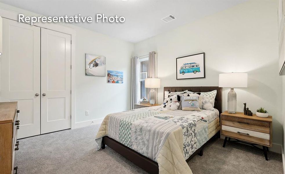 Carpeted bedroom with a closet