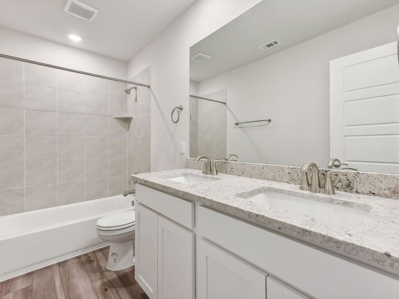 The upstairs full guest bathroom makes getting ready easier for everyone.