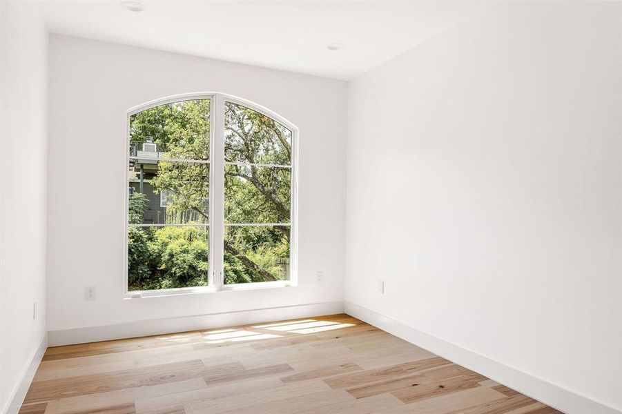 Mature trees surround the home and are seen through the large and thoughtfully placed windows.