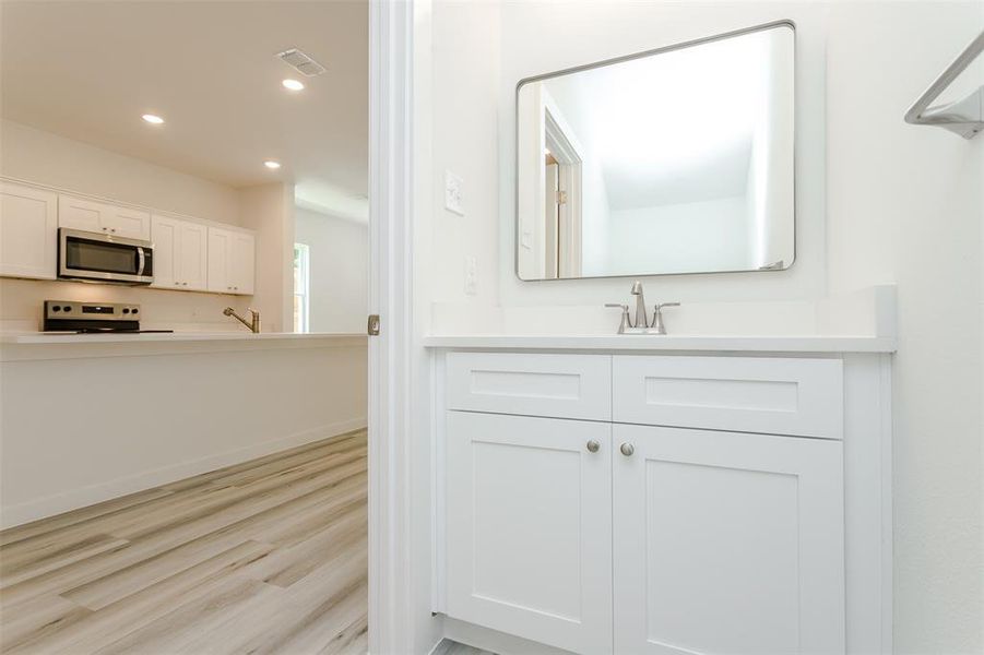 Bathroom featuring oversized vanity and hardwood / wood-style flooring