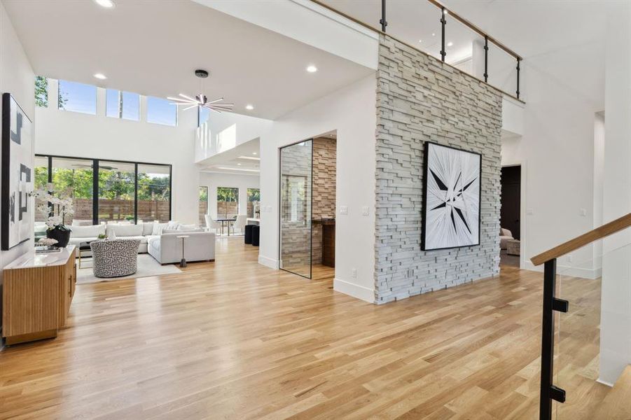 Another view from the entry captures the open and bright feel of the home. The stone accent wall, opposite of the front door, provides a great backdrop for your favorite piece of art.