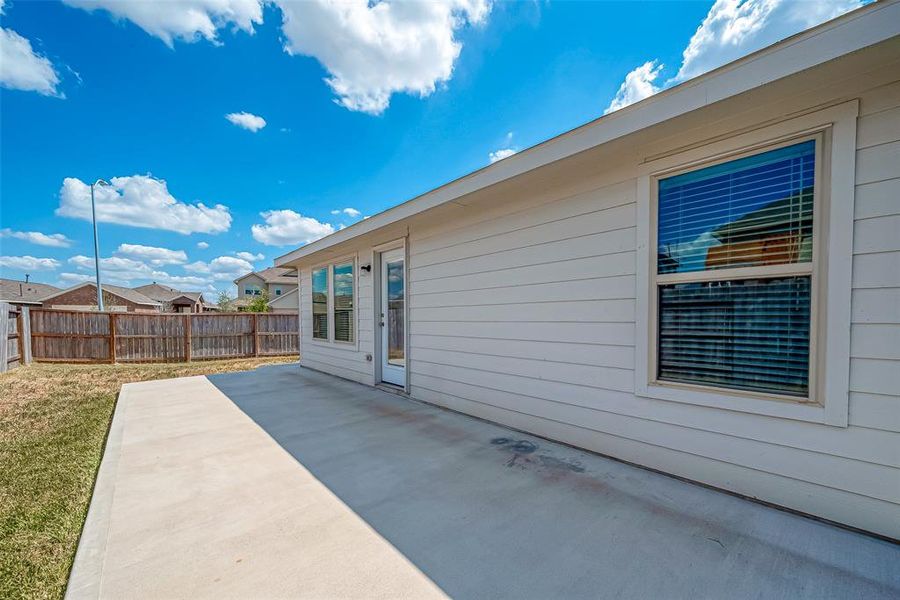 The large back patio provides plenty of space to entertain guests or enjoy a barbecue, making it the perfect spot for outdoor gatherings.