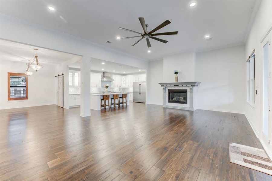 The kitchen seamlessly connects to the main living space, unified by the gorgeous floor.